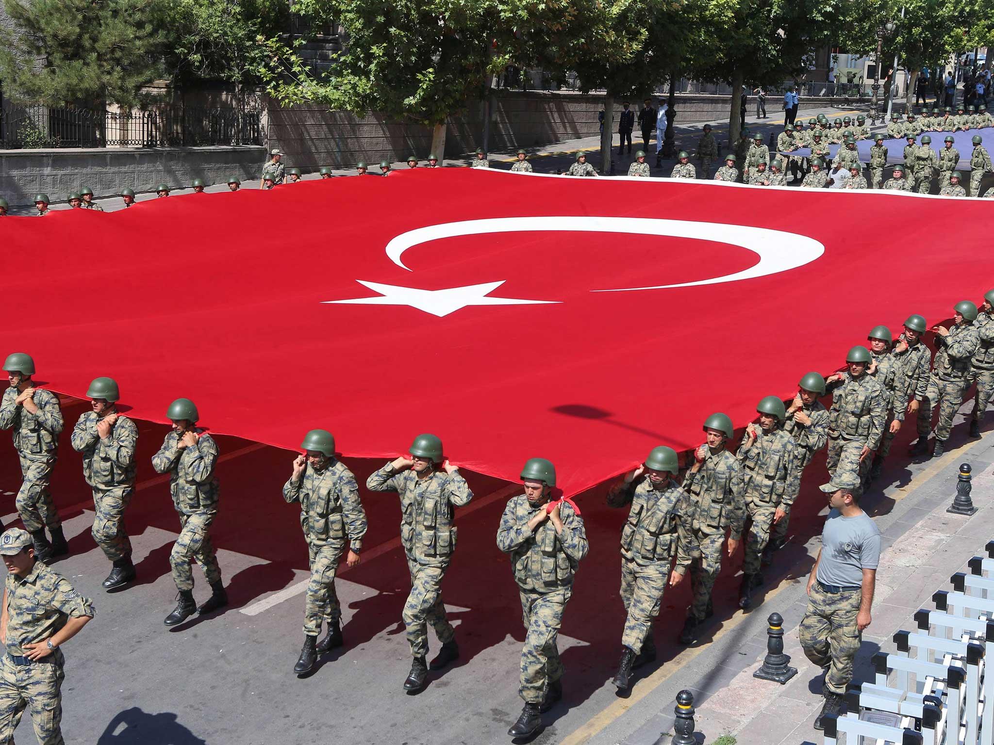 Turkish soldiers carry a giant Turkish flag during a ceremony to mark 94th anniversary of Turkeys Victory Day in Ankara on 30 August, 2016