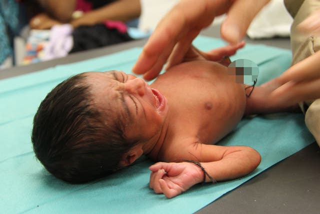 One of the five-day-old twins rescued by the MSF vessel the Dignity I off the coast of Libya on 29 August