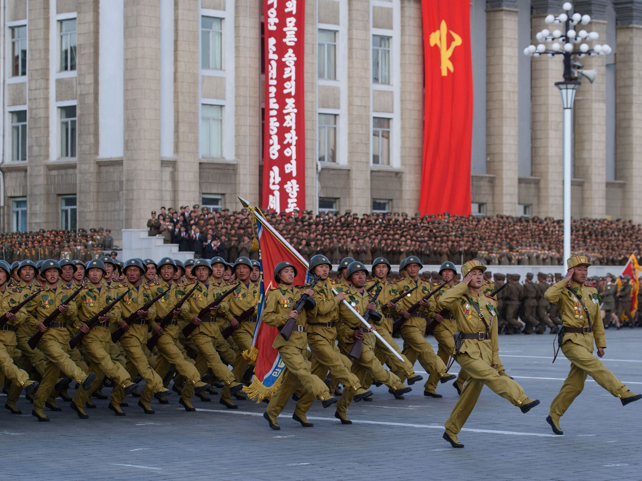 North Korean soldiers march during a mass military parade at Kim Il-Sung square in Pyongyang on October 10, 2015