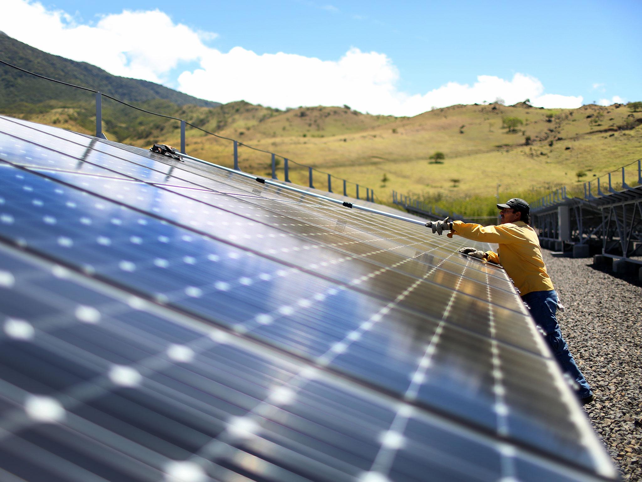 &#13;
A worker cleans the panels in a solar power park run by the Costa Rican Electricity Institute (ICE) on March 26, 2015 in Guanacaste, Costa Rica Joe Raedle/Getty Images&#13;