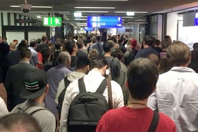 Passengers leave Terminal 1 as they are evacuated at Frankfurt airport in Frankfurt Main, Germany, 31 August 2016