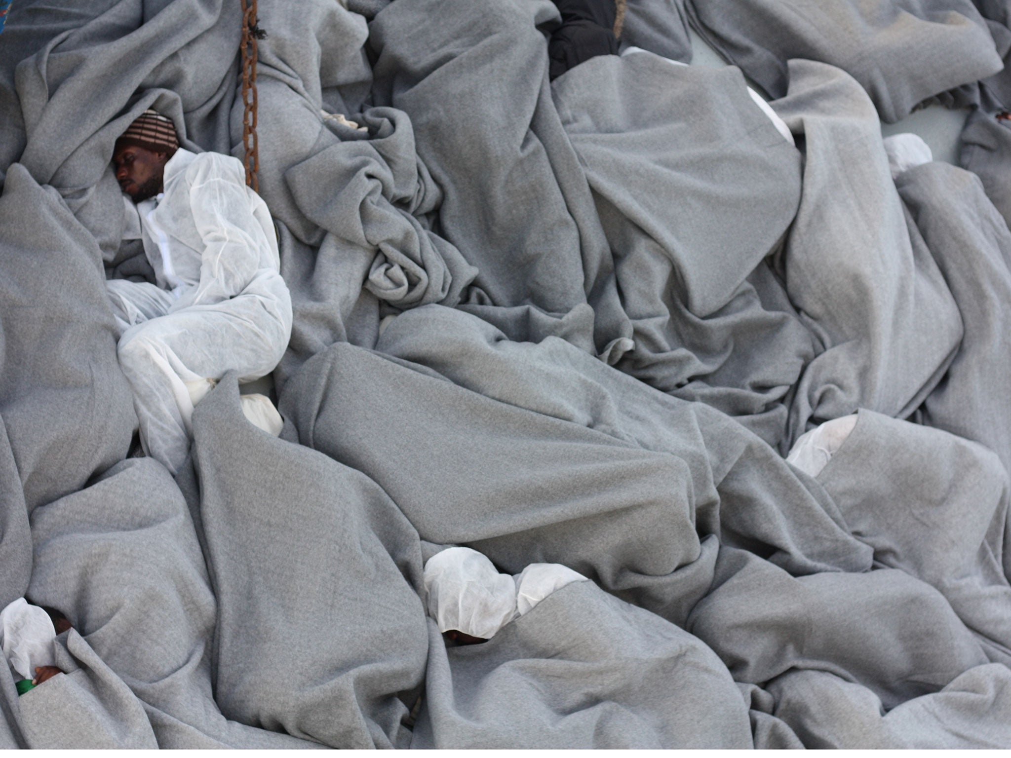 Refugees sleep on the deck of MV Aquarius