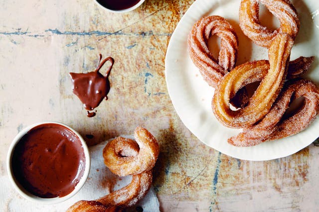 Homemade churros are fried choux pastry covered in sugar and dipped in chocolate sauce