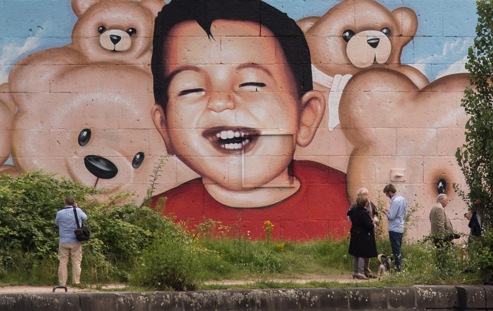 A graffiti mural featuring Syrian refugee Alan Kurdi in Frankfurt harbour (Getty Images)