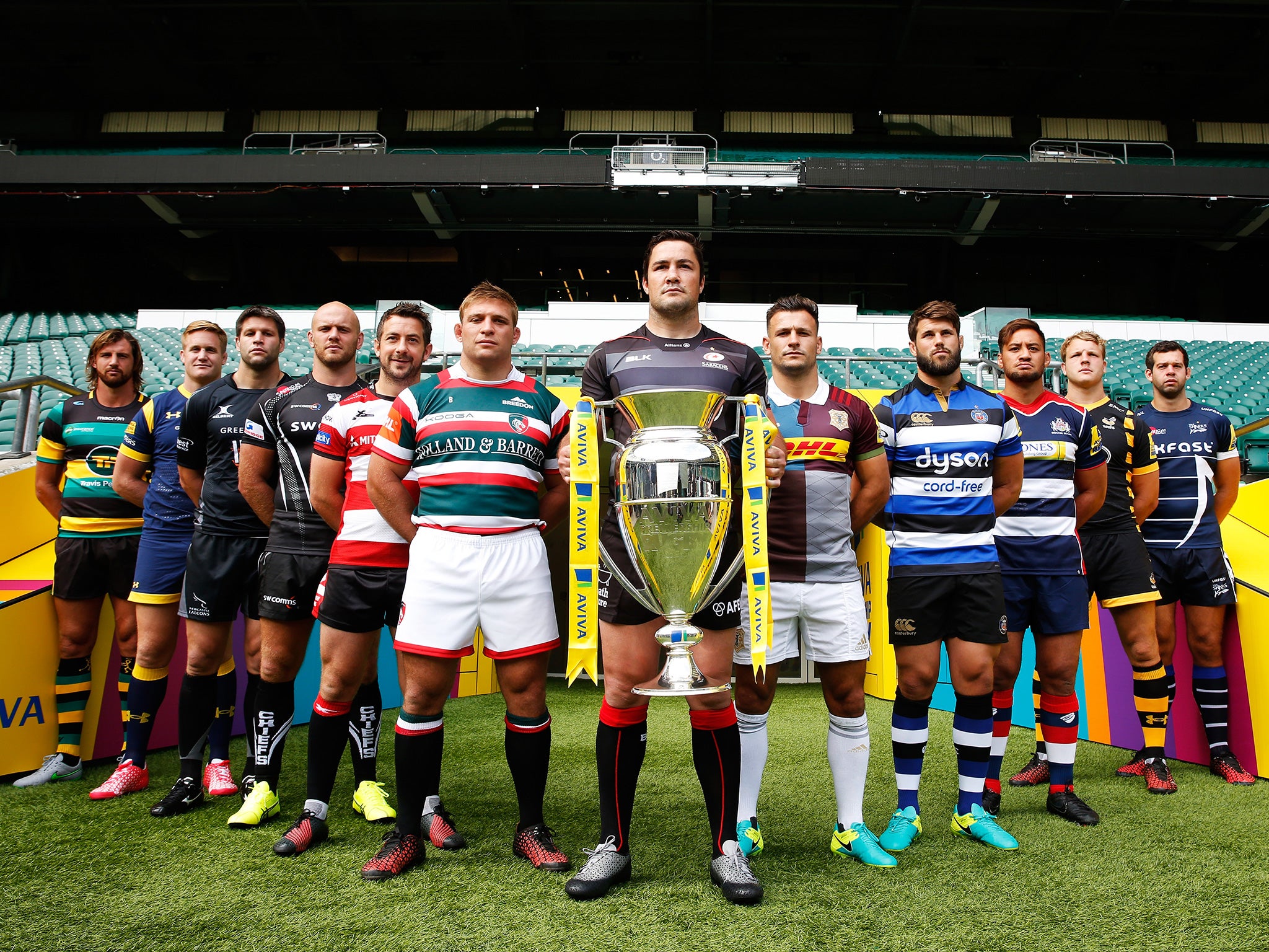 The captains of this season's 12 teams line up with the trophy at Twickenham