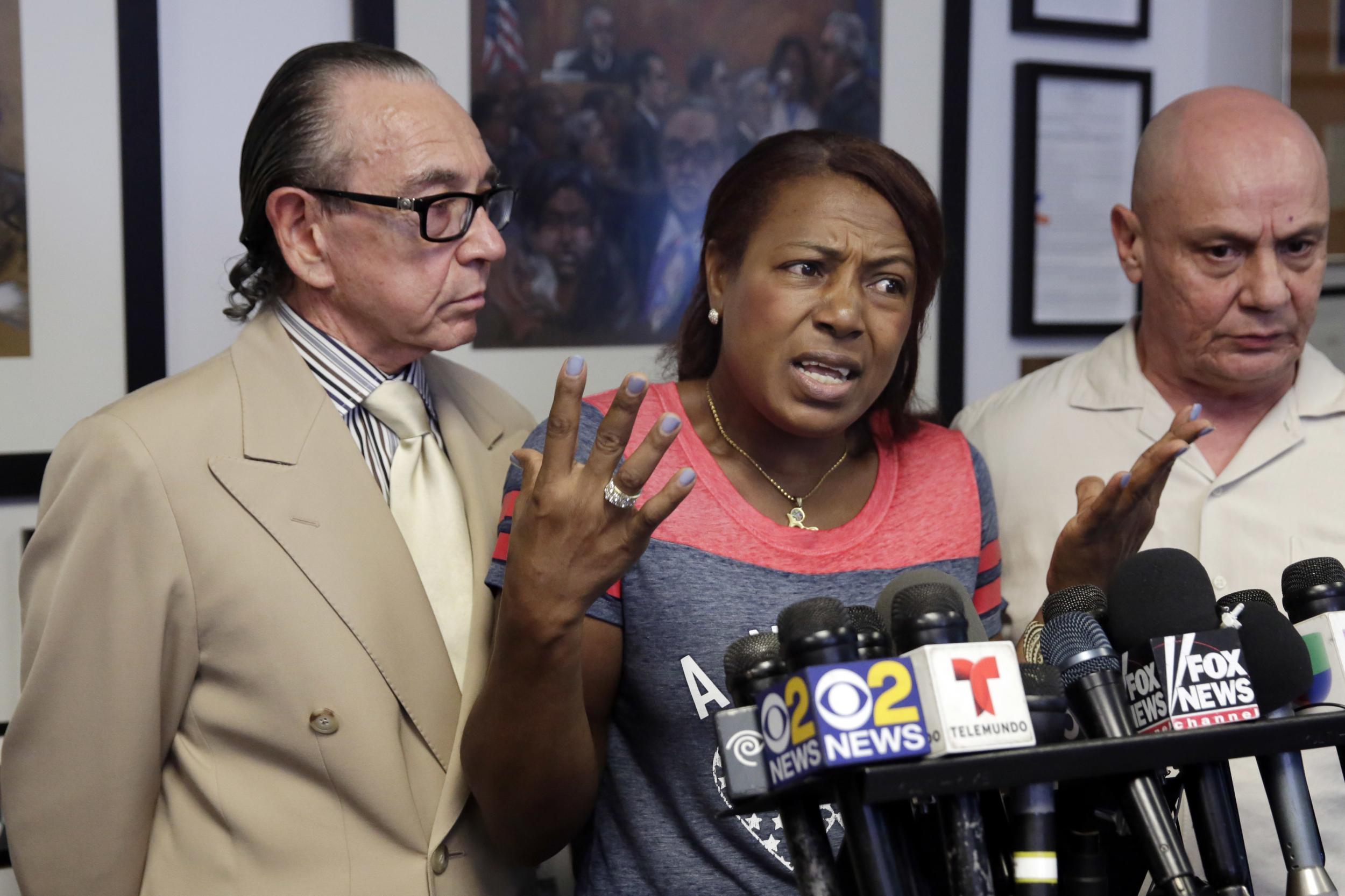 Maribel Martinez accompanied by her lawyer Sanford Rubenstein, left, and a translator at a news conference on Thursday