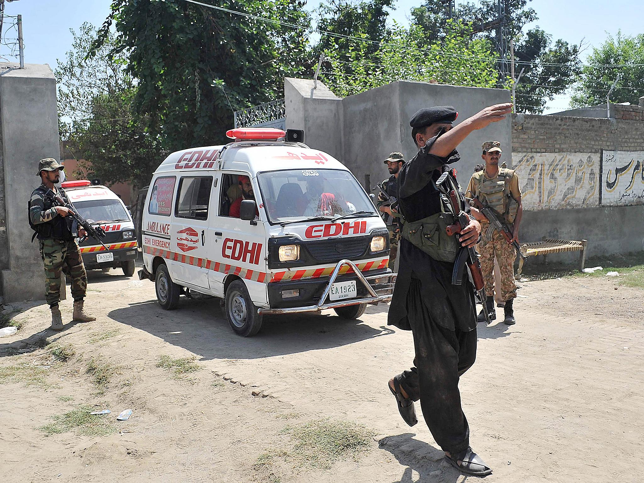 &#13;
Pakistani soldiers escort ambulances carrying the bodies of suicide bombers following one of the attacks &#13;