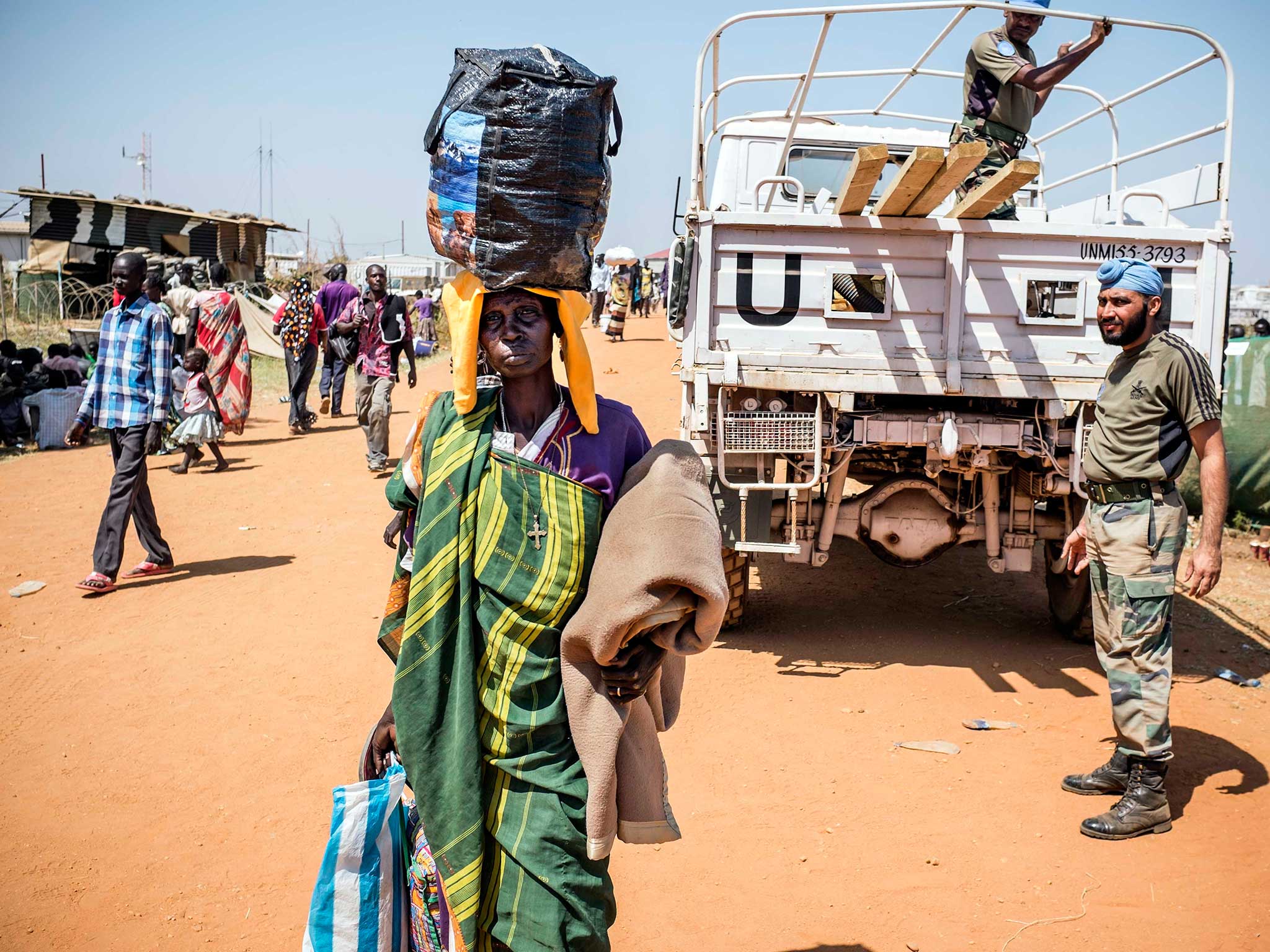 South Sudanese civilians fleeing an outbreak of intense fighting take shelter at the UN mission in Juba, 17 December 2013