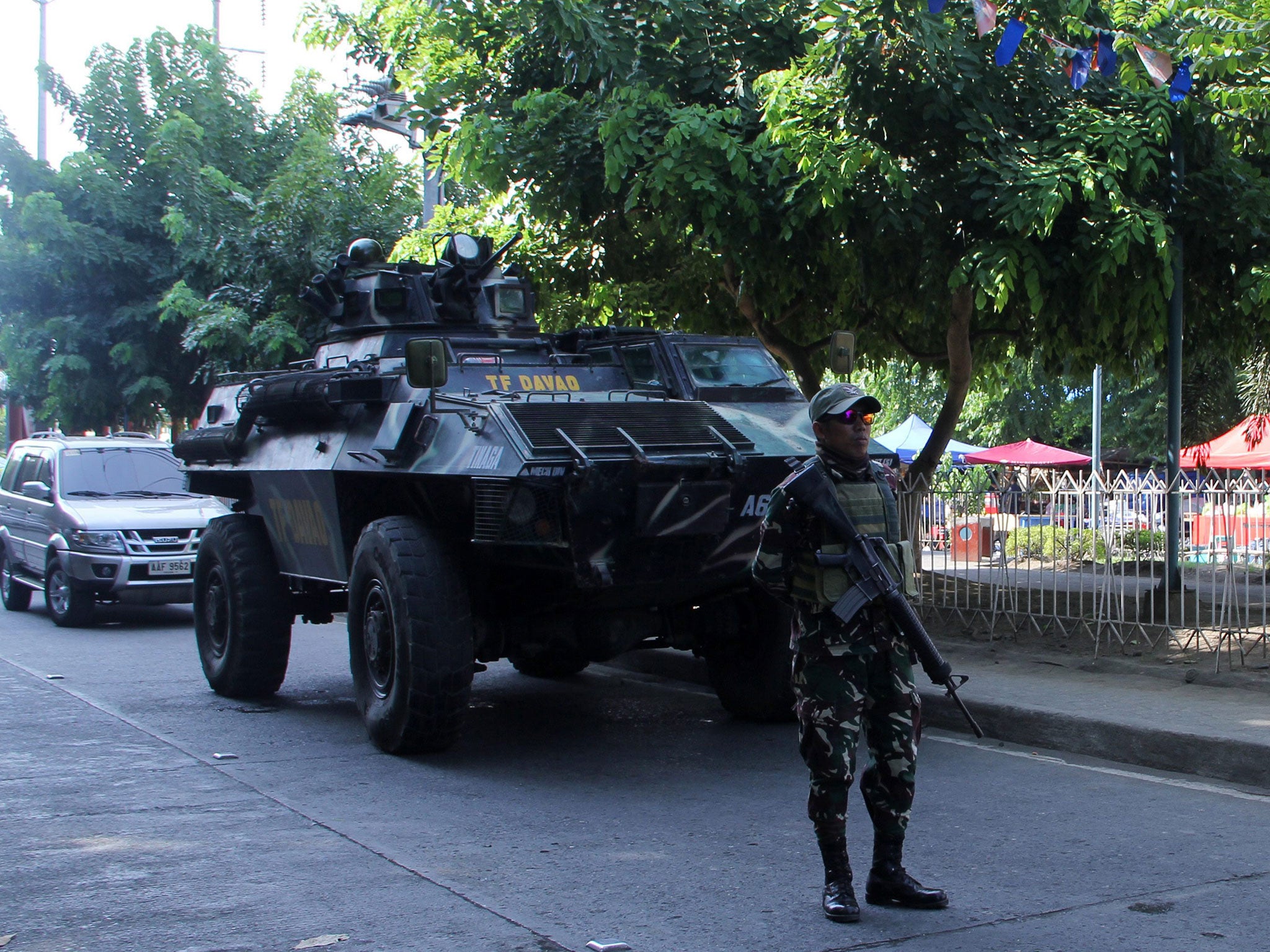 Filipino soldiers man a military checkpoint near the site of an explosion at a night market in Davao city, Philippines, on 3 September