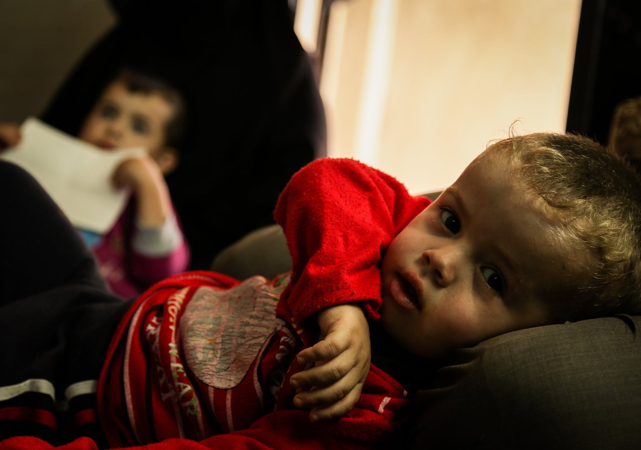 Basheer, a 3-year-old Syrian boy, lying on his father leg, lives with his family in a rent-free house as part of NRC's shelter programme in the village of Bair-Ras, in Irbid governorate, northern Jordan. Photo 11 October 2015