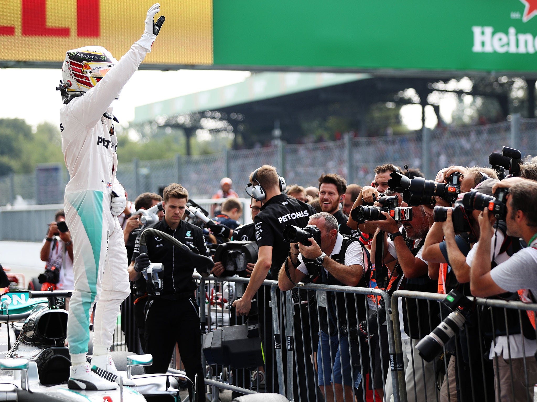 &#13;
Lewis Hamilton waves to the crowd after securing pole position &#13;