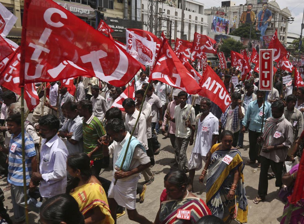 Indian workers participate in a rally during a nationwide strike called by trade unions in Hyderabad, India