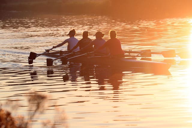 Rowers work out along the river Cam at sunrise in Cambridge, as the warm weather looks set to continue