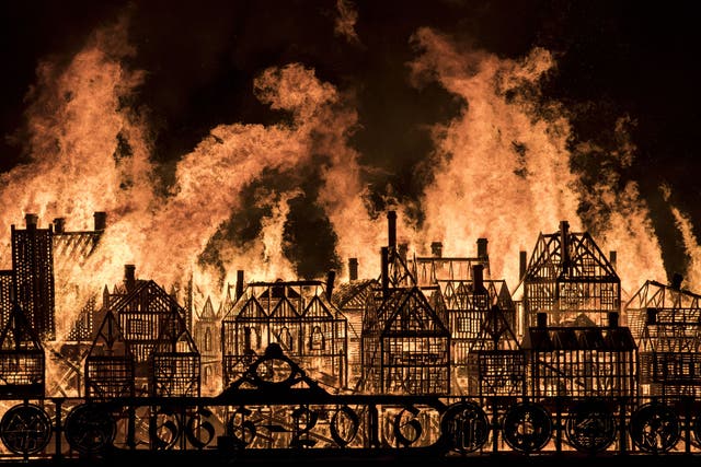 Crowds gathered on the banks of the Thames to watch the 120-metre long model go up in flames.