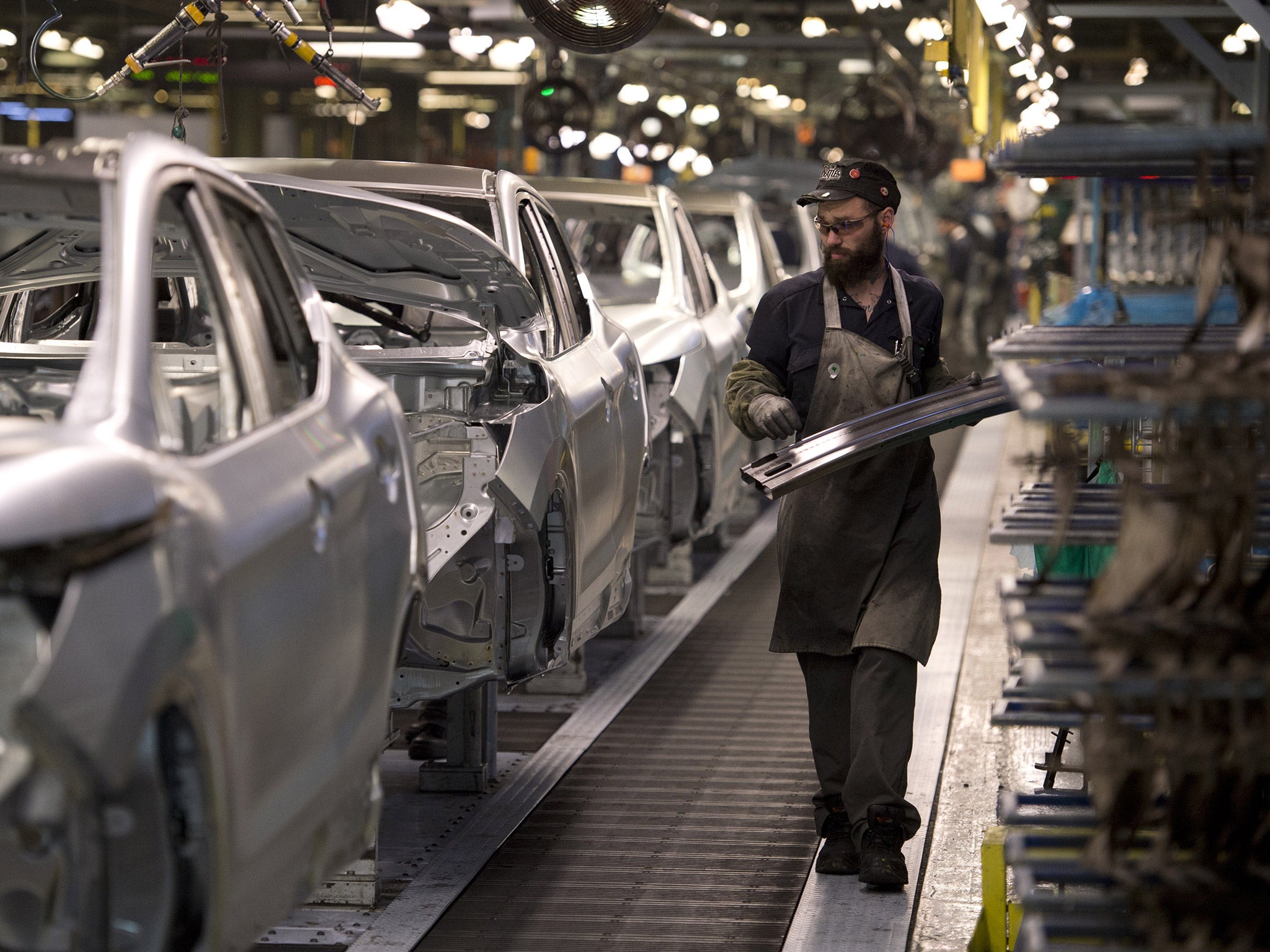 A member of Nissan's manufacturing staff works in the body shop at their plant in Sunderland