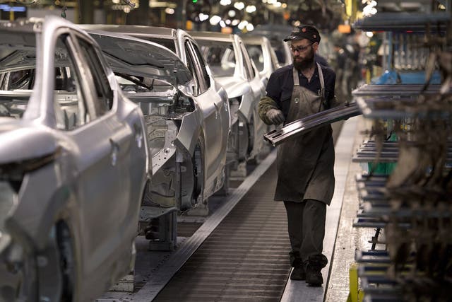 A member of Nissan's manufacturing staff works in the body shop at their plant in Sunderland