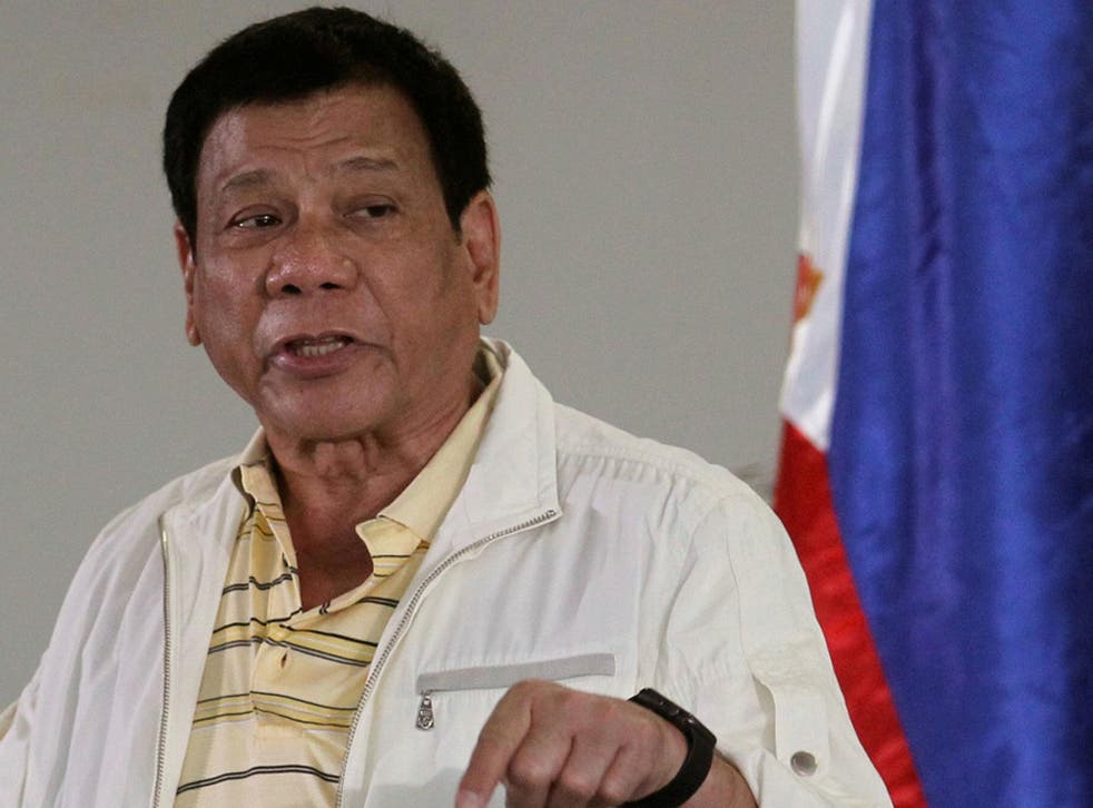 Philippines' President Rodrigo Duterte speaks to reporters before departing to Laos