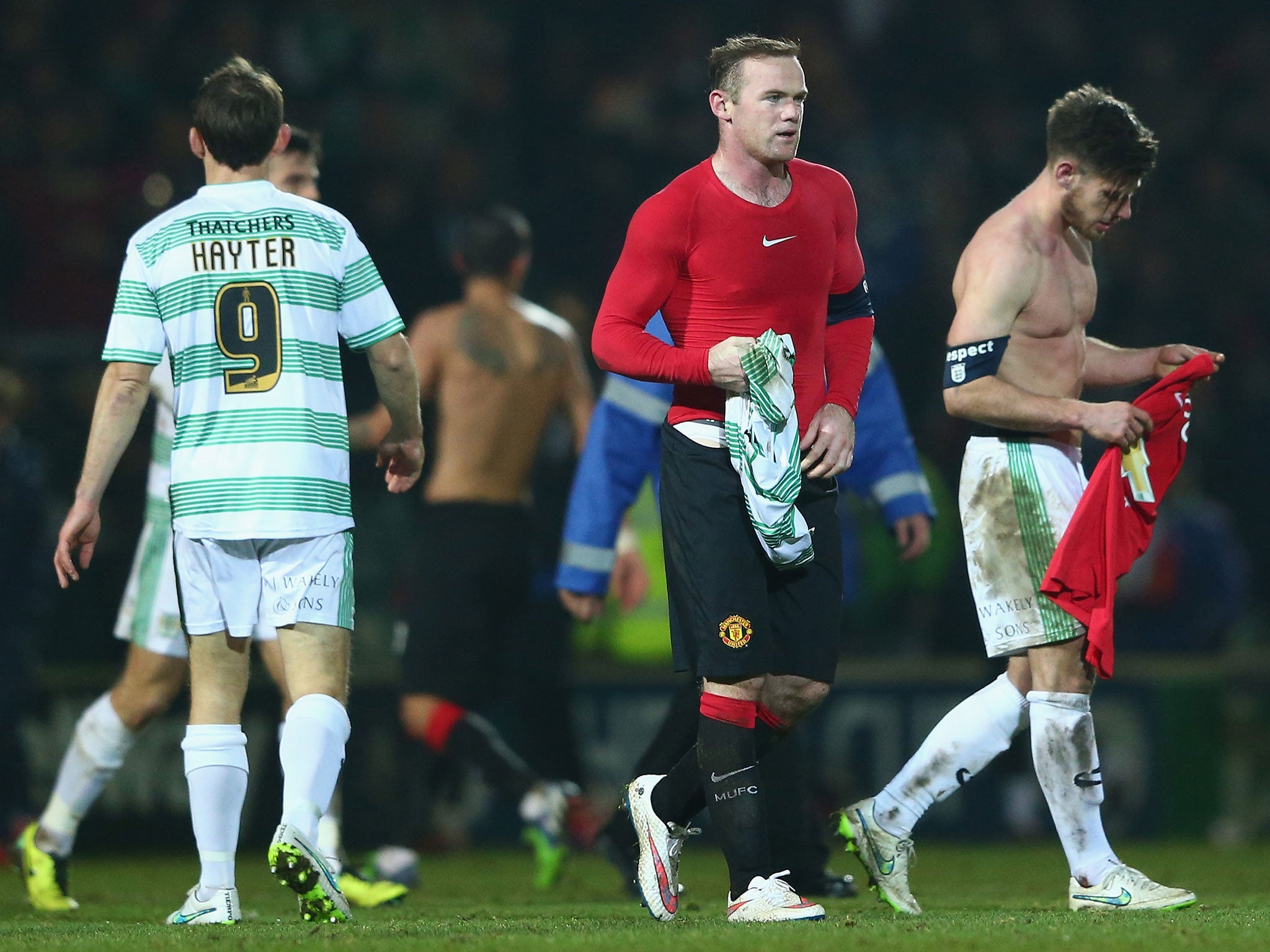 Joseph Edwards (R) of Yeovil Town swaps shirts with Wayne Rooney in the third round of the FA Cup