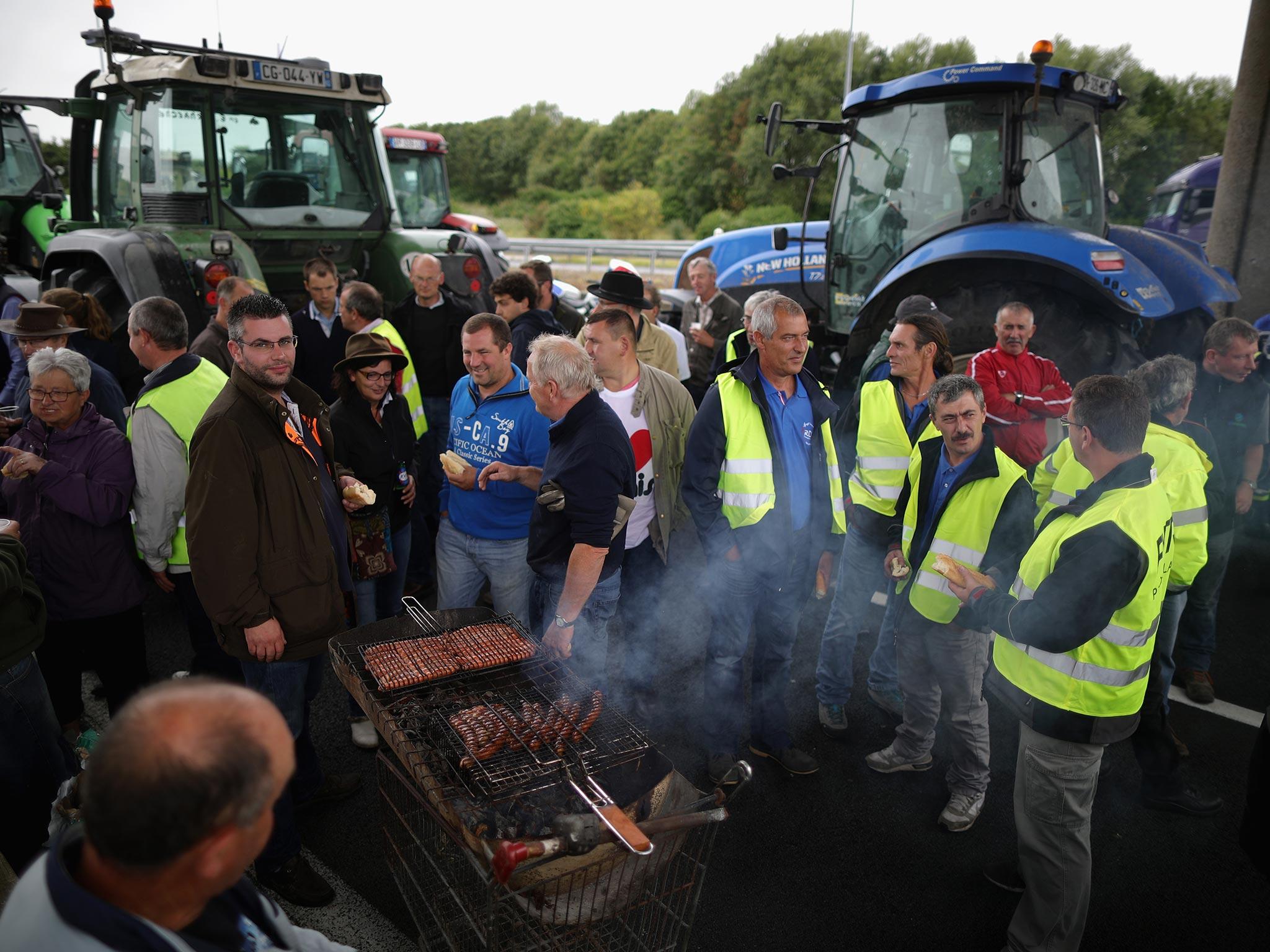 French farmers cook on a barbecue during their blockade