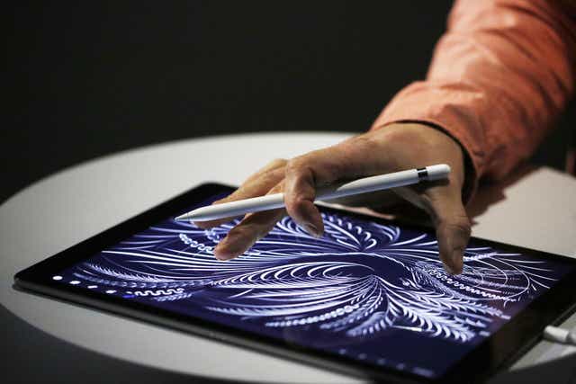 A man uses the new Apple Pencil on an iPad Pro after an Apple special event at Bill Graham Civic Auditorium September 9, 2015 in San Francisco, California