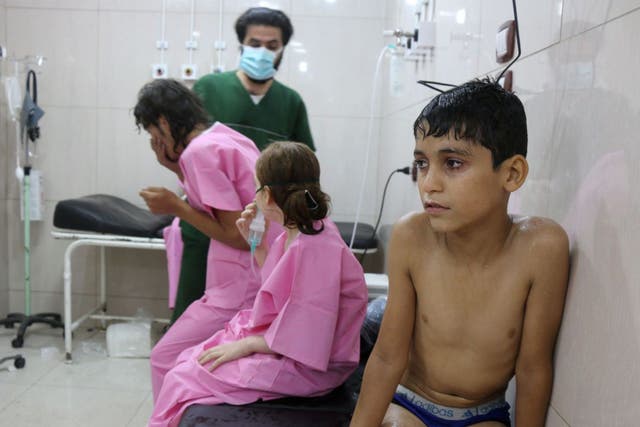 A Syrian boy waiting to be treated at a makeshift hospital in Aleppo on 6 September
