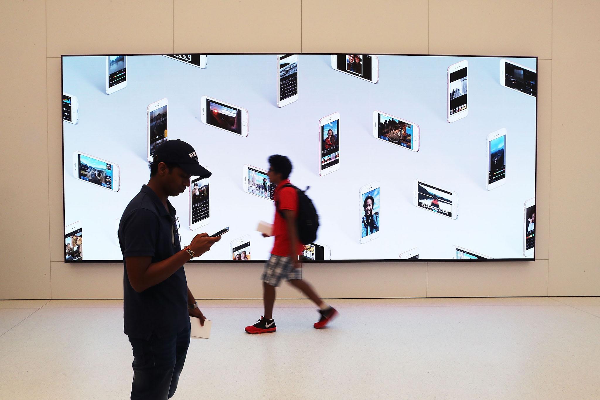 Customers shop at the new Apple Store at the 350,000 square-foot World Trade Center shopping mall at the Oculus on opening day on August 16, 2016 in New York City