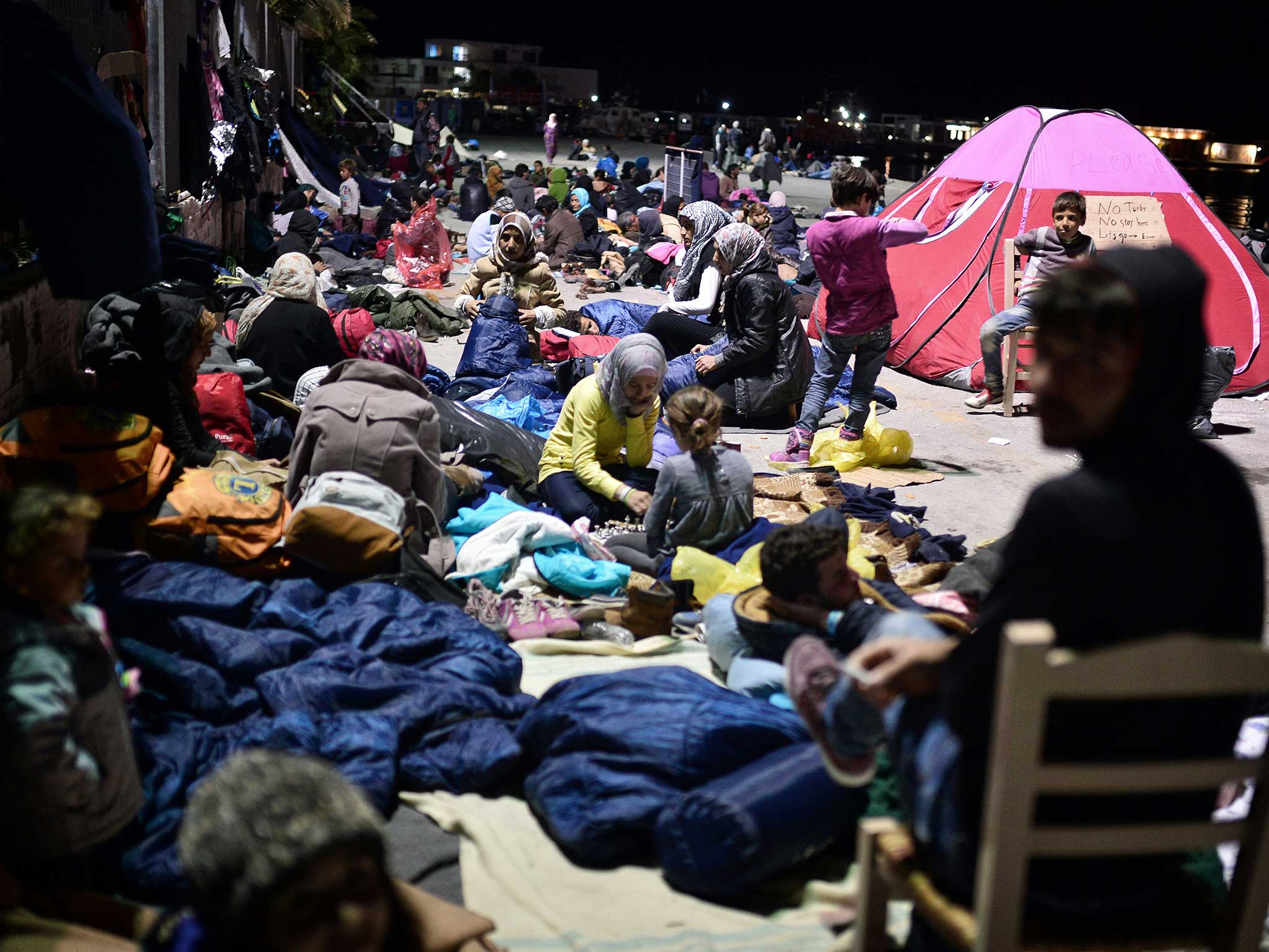 Refugees prepare to sleep at the port in the Greek town of Chois