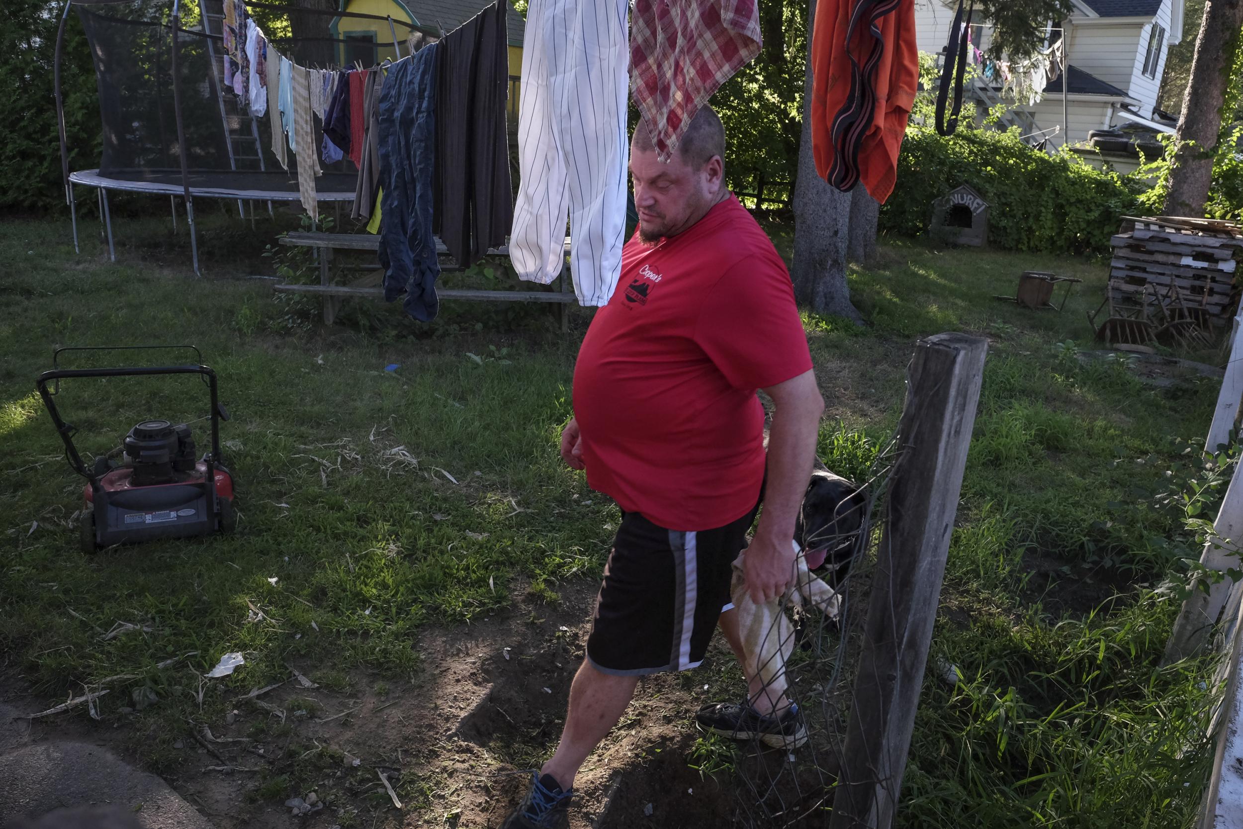 Maureen's father Michael cleans the back yard of their home in Auburn, Massachusetts