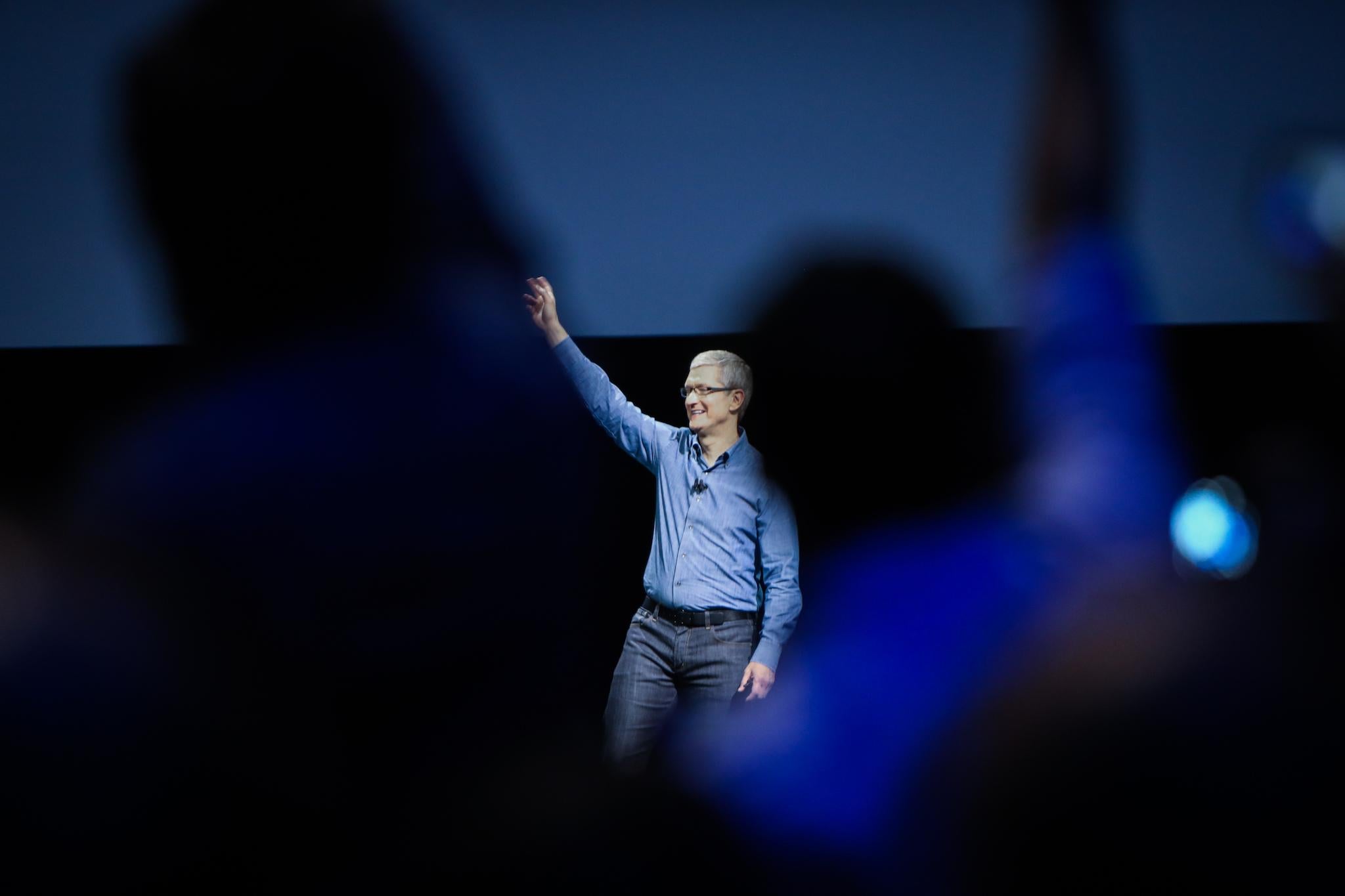 Apple CEO Tim Cook waves to the crowd as takes the stage at Apple's annual Worldwide Developers Conference at the Bill Graham Civic Auditorium in San Francisco, California, onJune 13, 2016