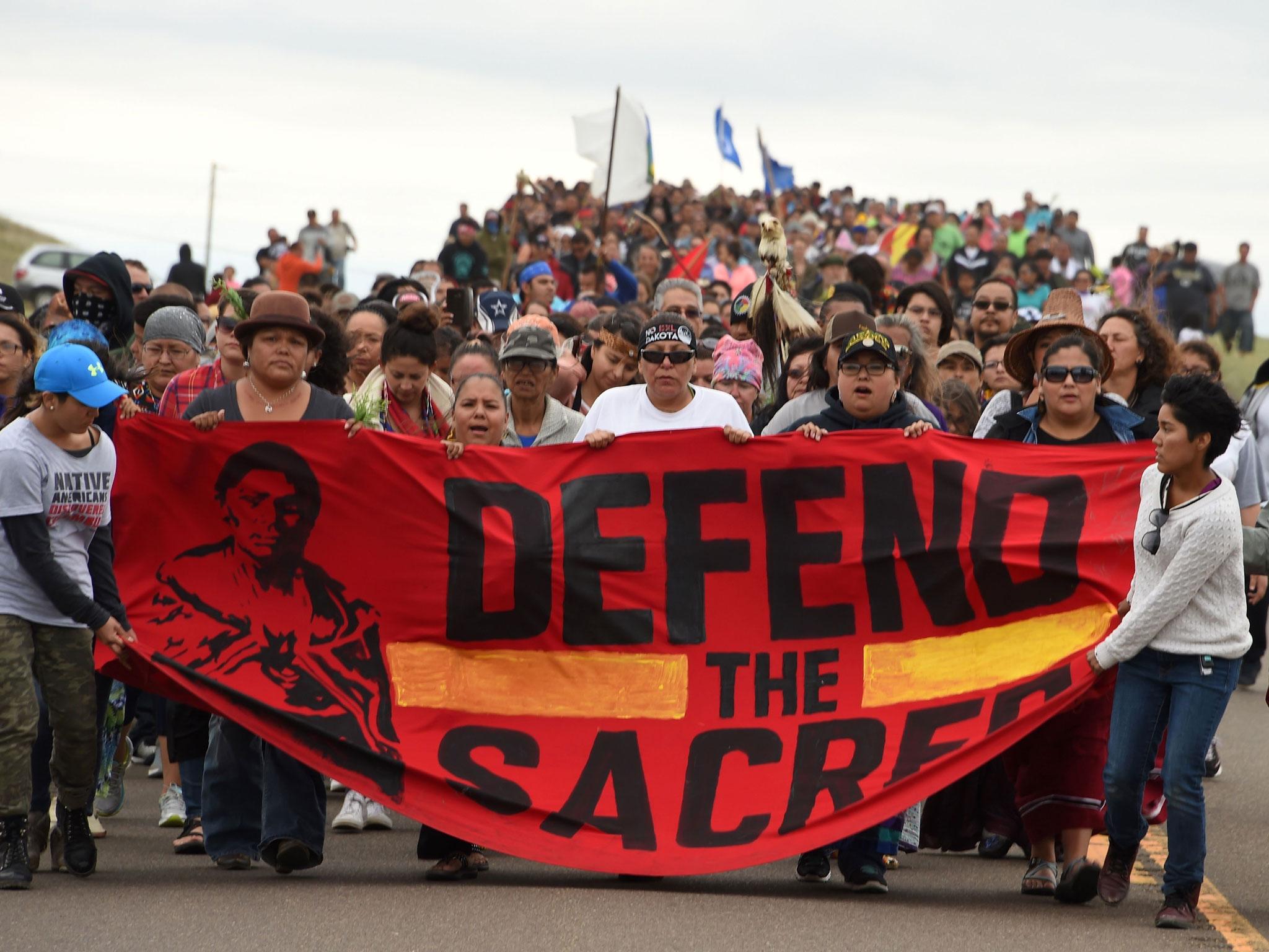 Native Americans march to the site of a sacred burial ground that was disturbed by bulldozers building the Dakota Access Pipeline