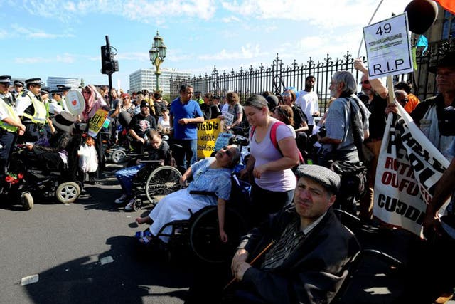 Protesters block part of Westminster Bridge in central London as they demonstrate against disability benefit cuts