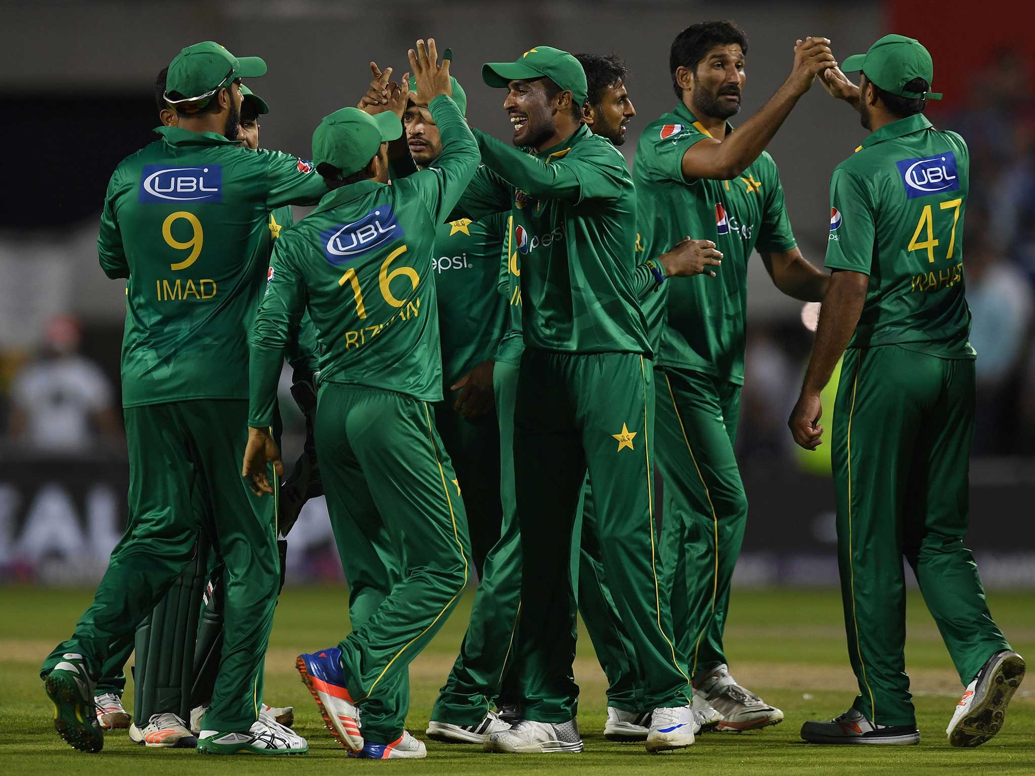 The Pakistan players celebrate their comfortable victory against England