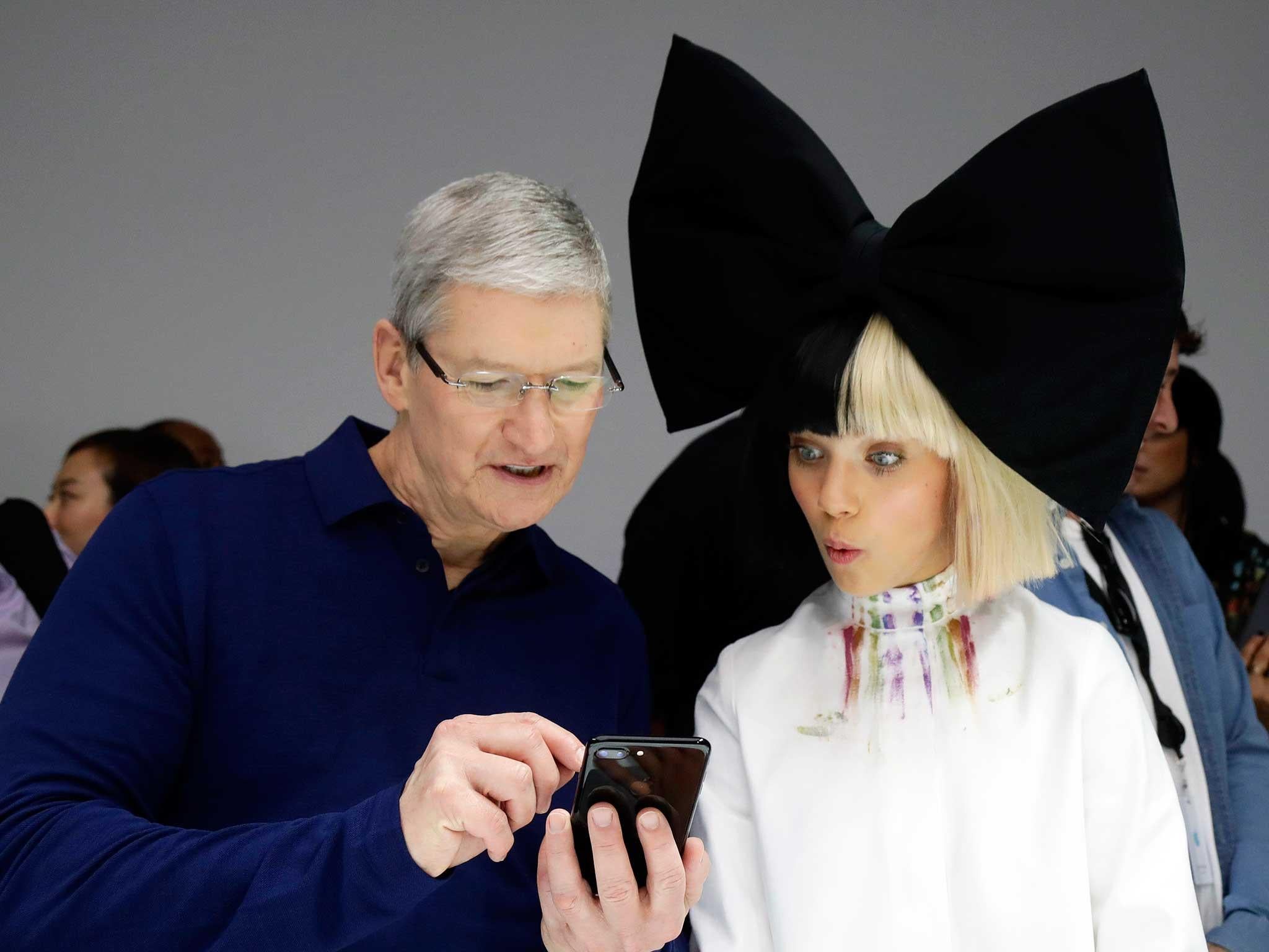 Apple CEO Tim Cook demonstrates an iPhone 7 at the product launch earlier this month