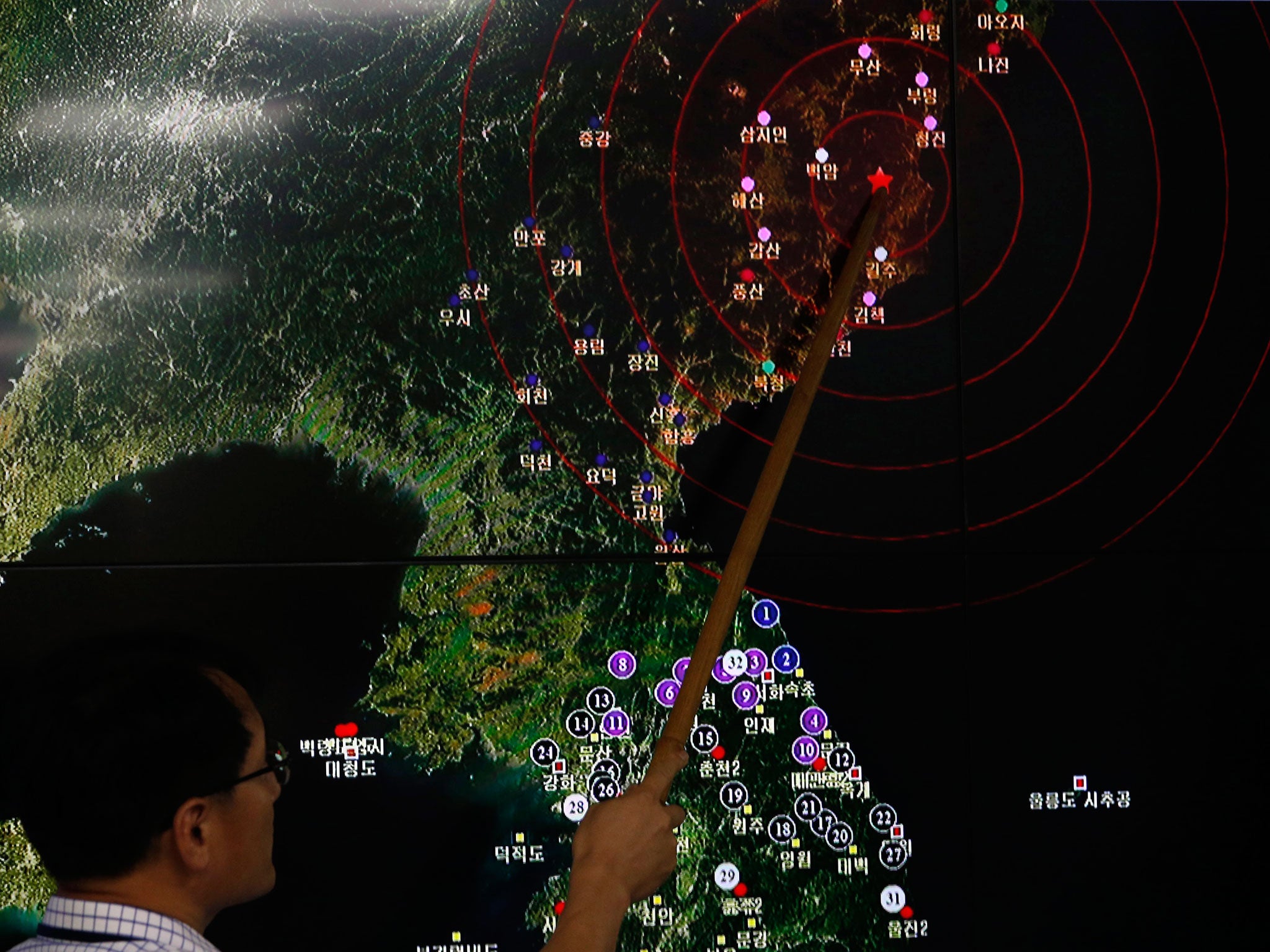 Ryoo Yong-Gyu, director of the earthquake monitoring division of South Korea's Meteorological Administration, shows seismic activity from a test in North Korea in Seoul on 9 September