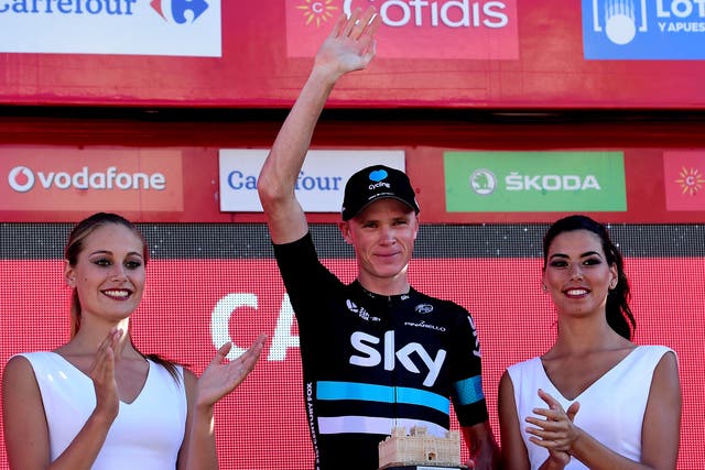 Chris Froome celebrates his time trial victory on the podium