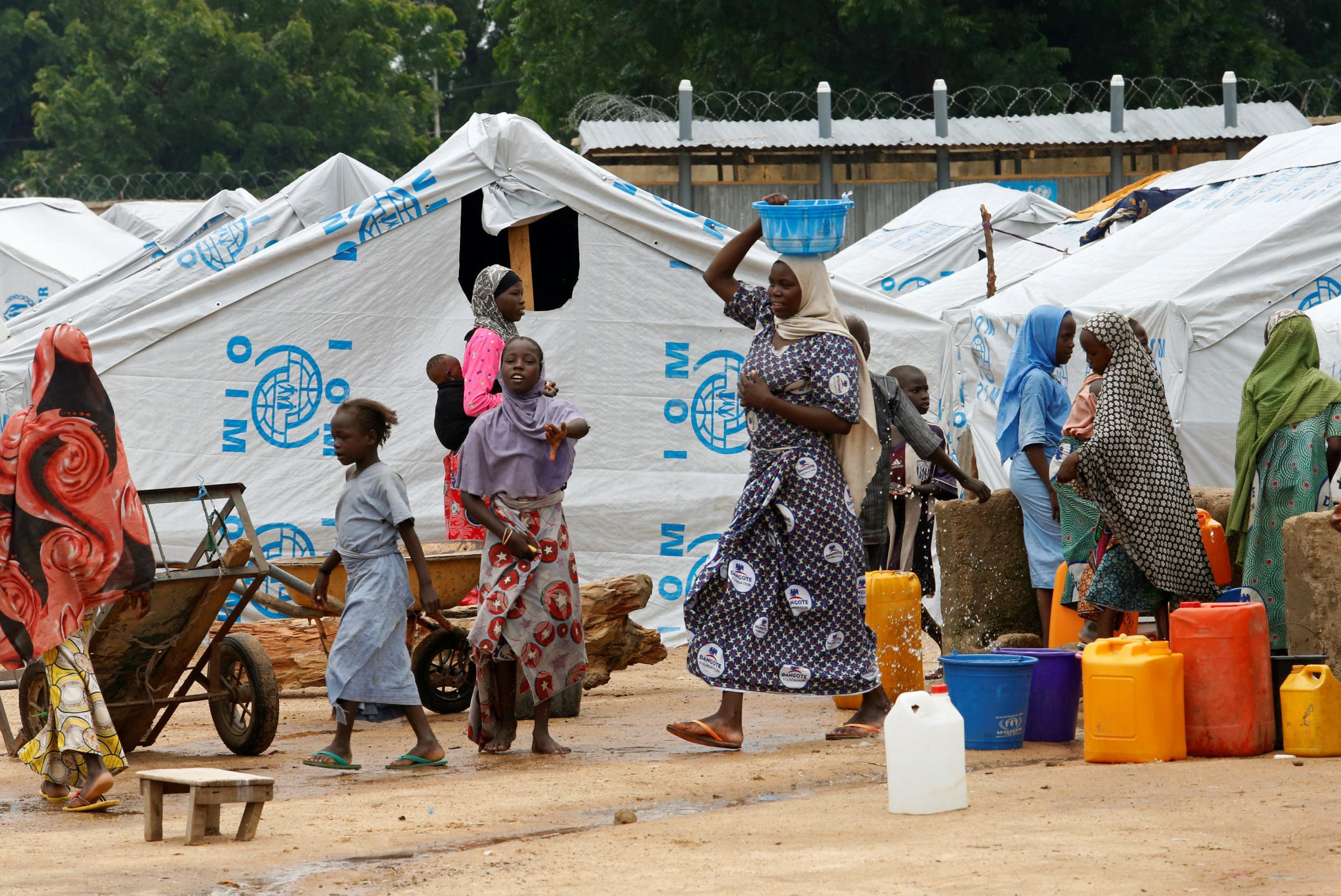 Women gather at a water station in a camp for internally displaced people in Bama, Borno state