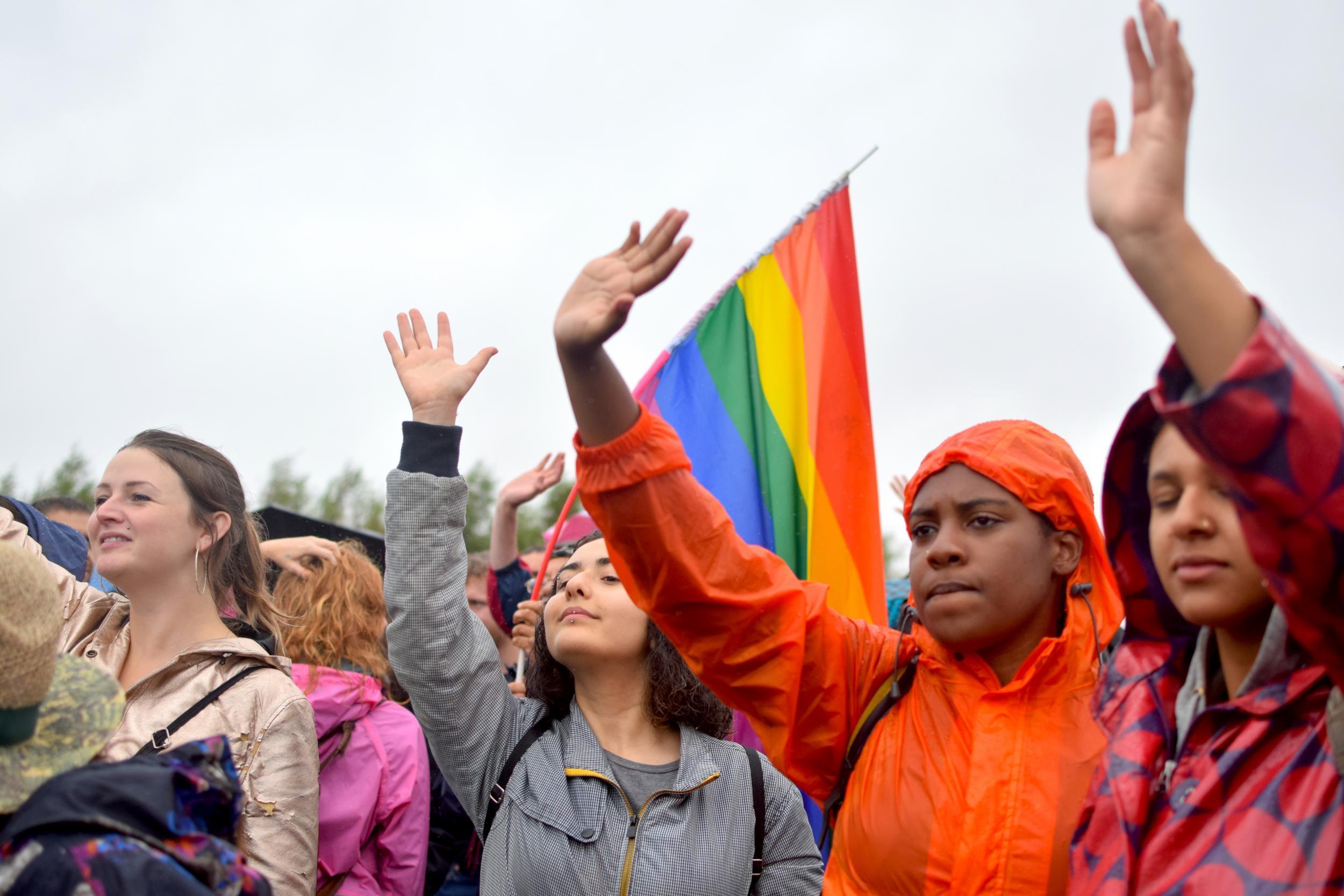 Immigration rights activists wave to the Yarl's Wood detainees