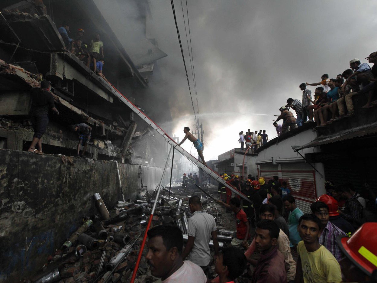 Firefighters attempt to extinguish a fire at a factory in the Tongi industrial area