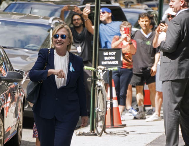 Ms Clinton walks, smiling and unaided, out of her daughter's apartment shortly after the stumble