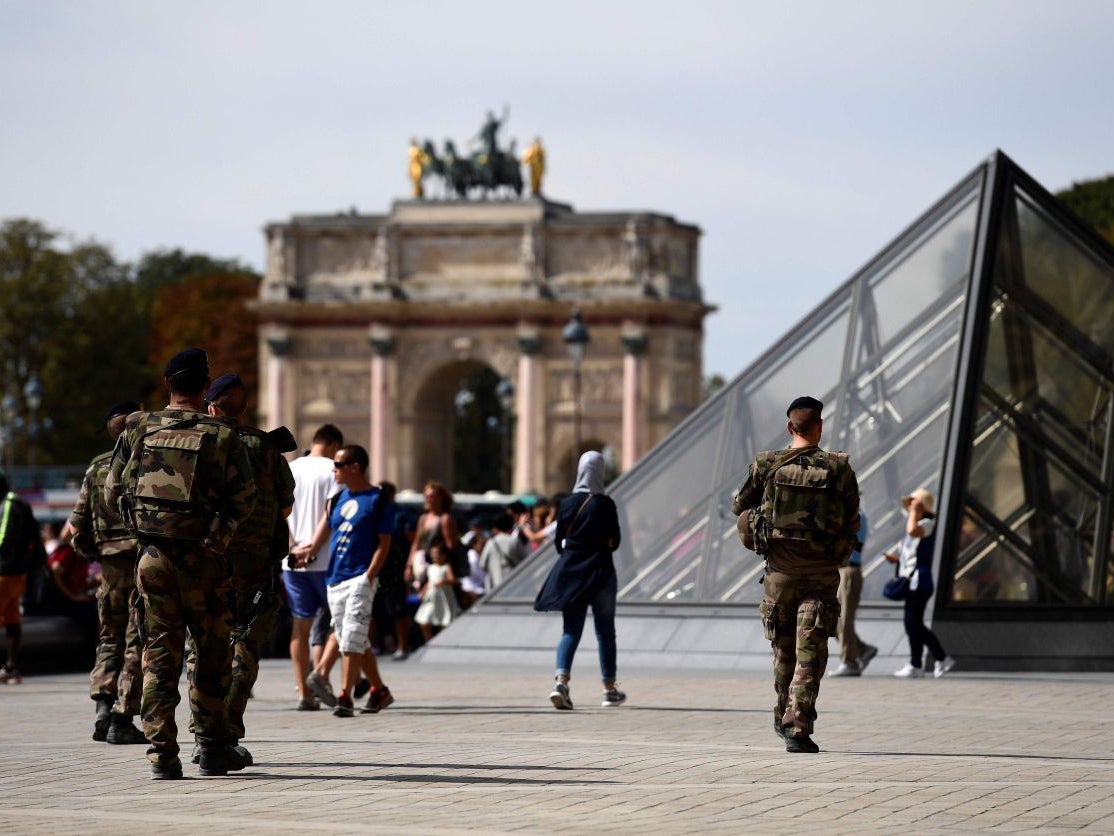 Soldiers patrol around the Louvre Museum in Paris