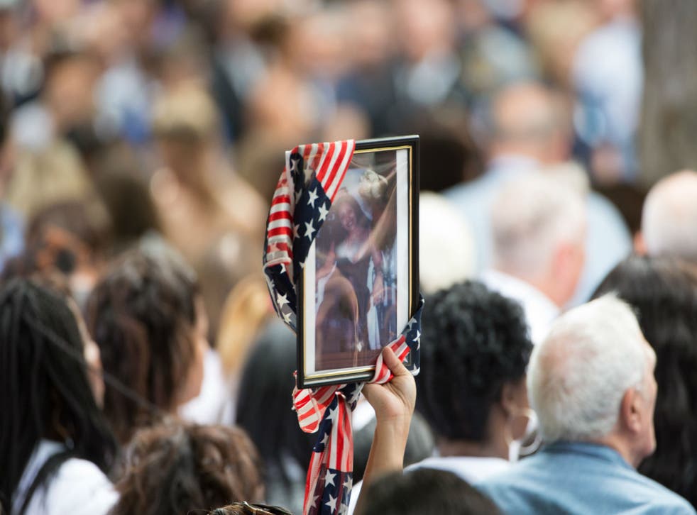 A victim’s portrait is carried at a ceremony in New York on Sunday during the 9/11 commemorations