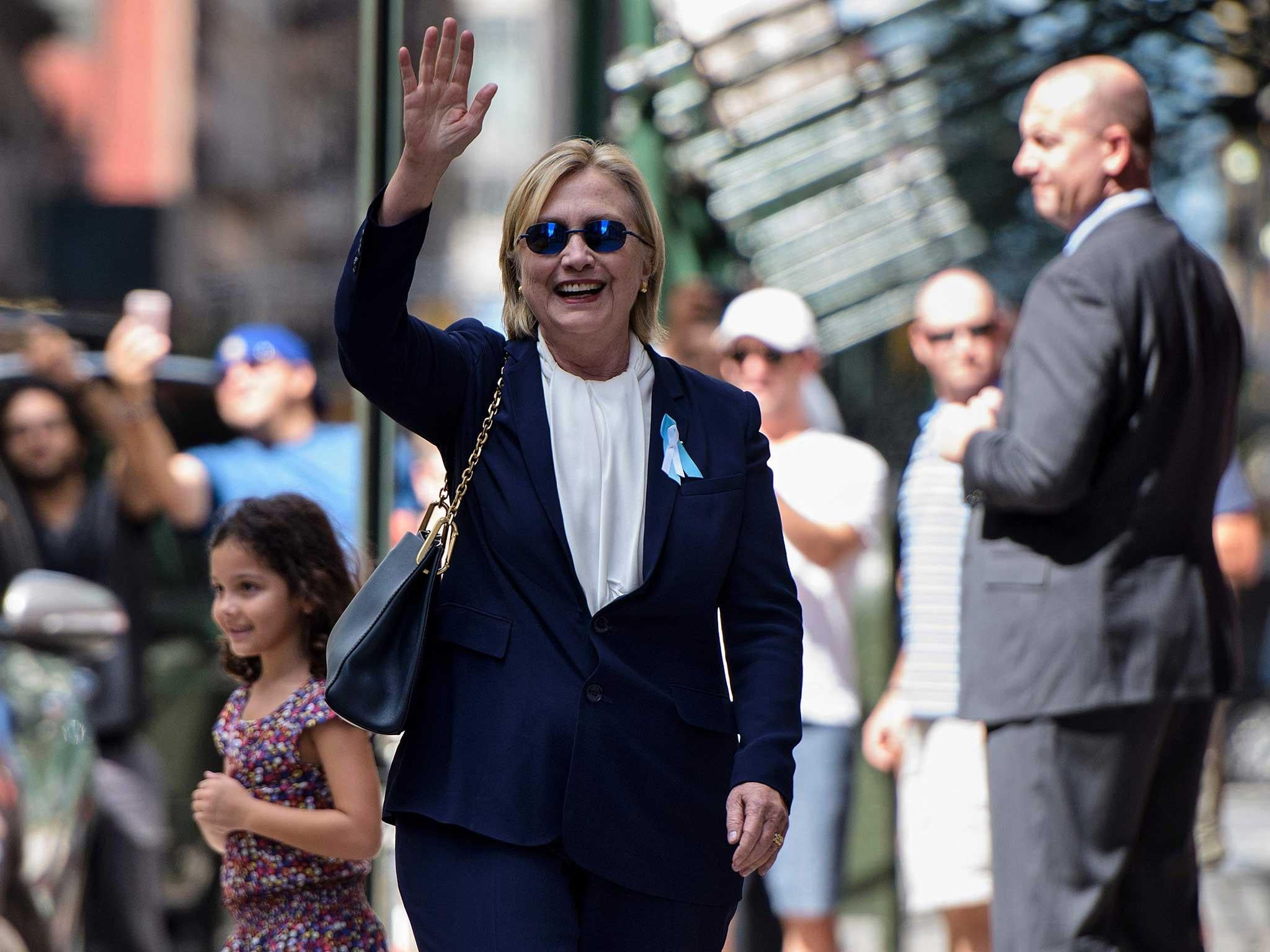 Hillary Clinton waves to the press as she leaves her daughter's apartment building in New York (Getty )