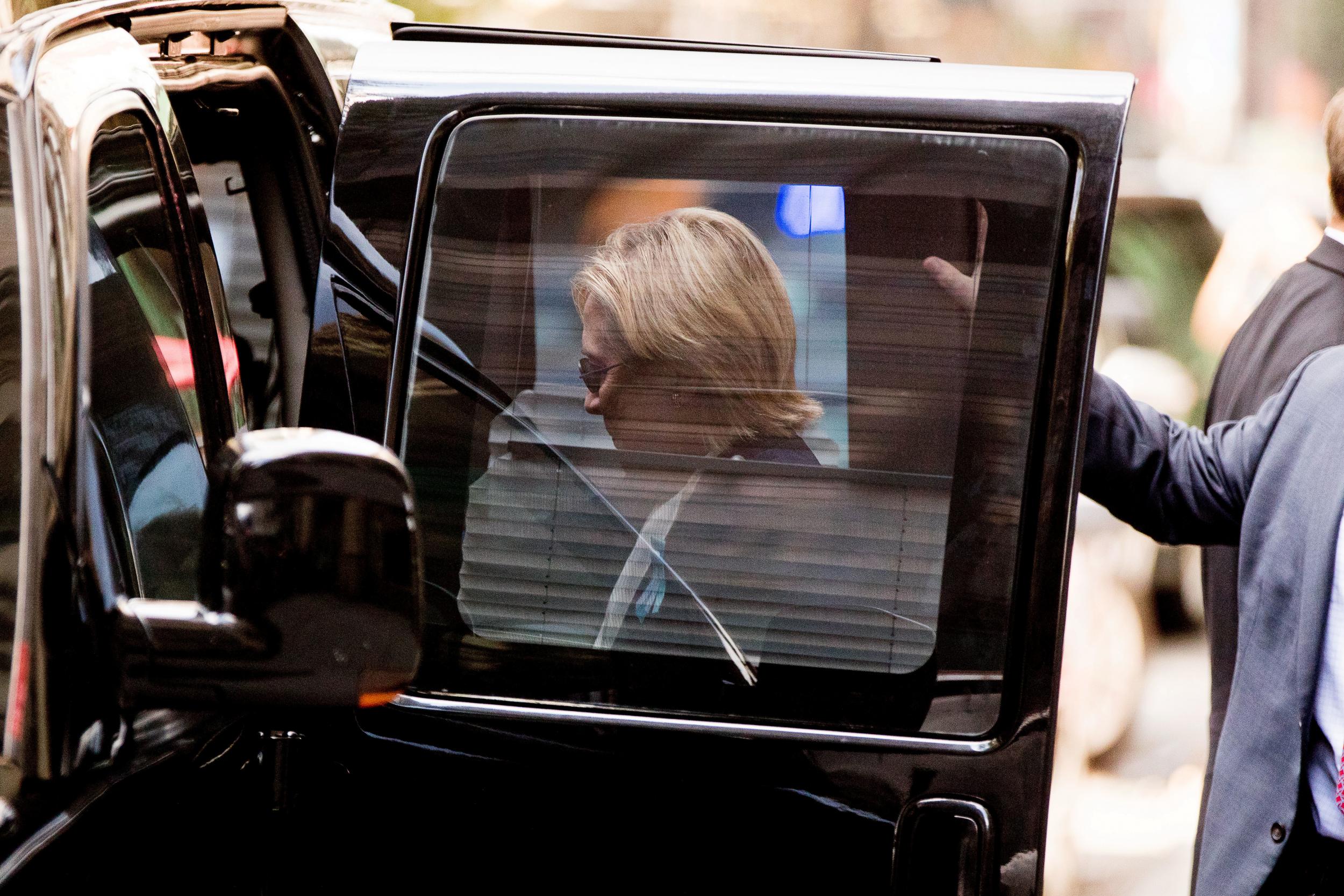 Hillary Clinton gets into a van as she leaves an apartment building in New York hours after she left the 9/11 anniversary memorial early