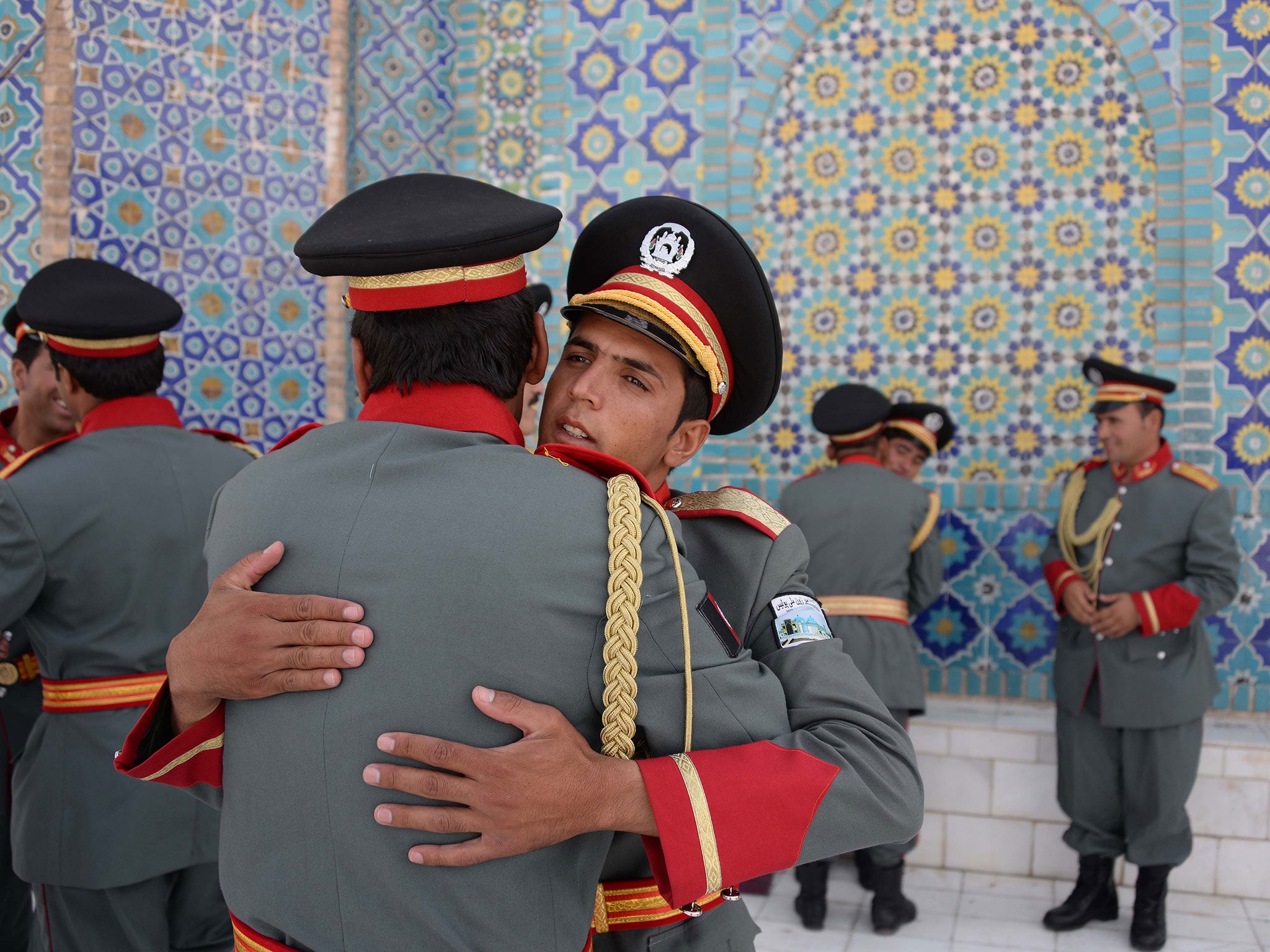 Members of an Afghan guard of honour greet each other after offering Eid-al-Adha prayers at the Hazrat-i- Ali shrine in Mazar-i Sharif on September 12, 2016