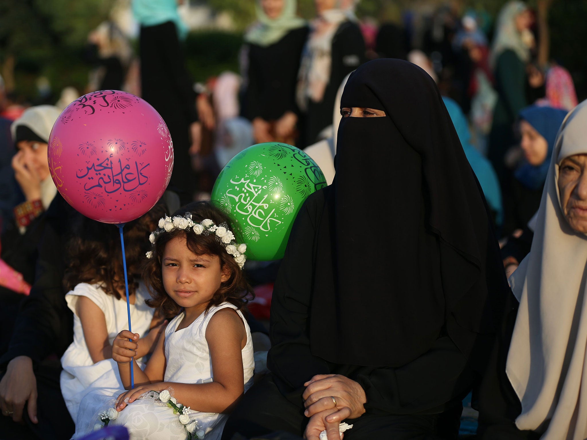 A Palestinian girl attends the morning prayer of Eid al-Adha on September 12, 2016