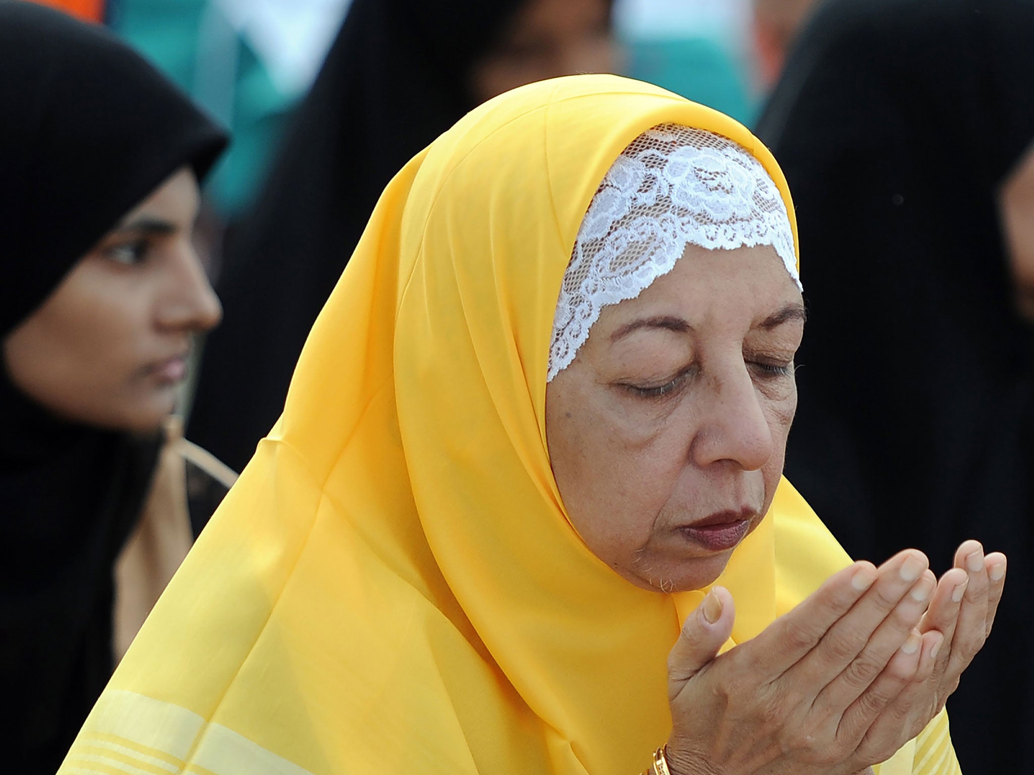 A Sri Lankan Muslim woman prays during Eid Al-Adha celebrations at the Galle Face esplanade in Colombo on September 12, 2016.