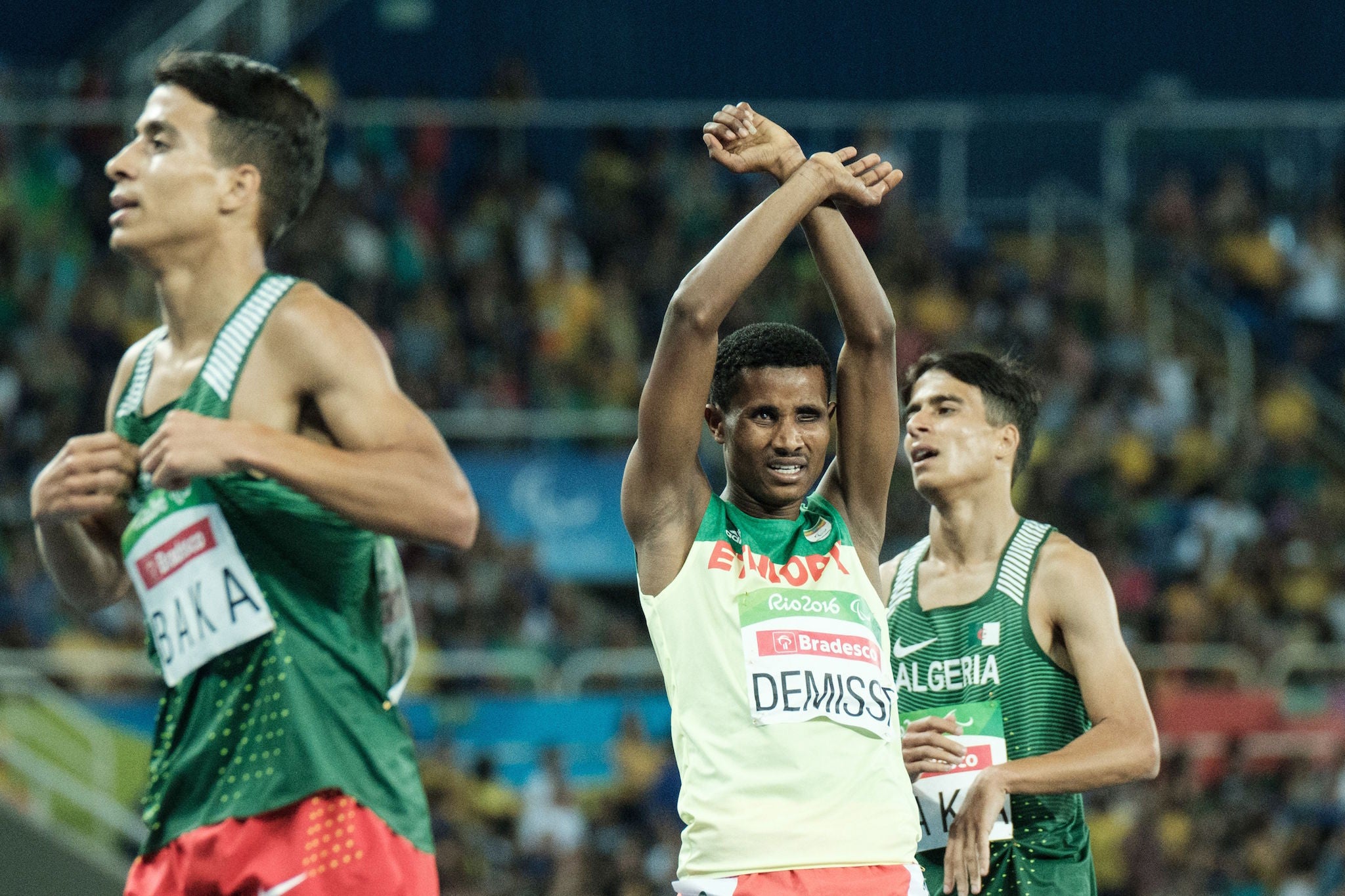 Ethiopia's Tamiru Demisse (C) reacts after the final of men's 1500 m (T13) of the Rio 2016 Paralympic Games at the Olympic stadium in Rio de Janeiro on September 11, 2016