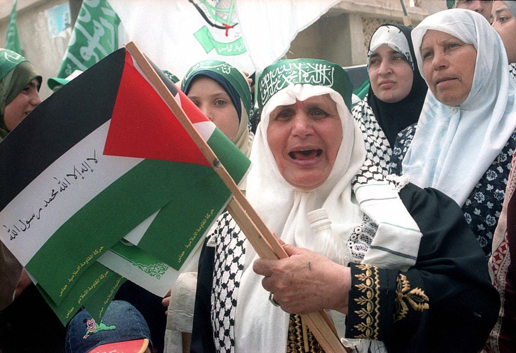 File photo of Palestinian women carry their national flags in a demonstration in support of Islamic militant movement Hamas