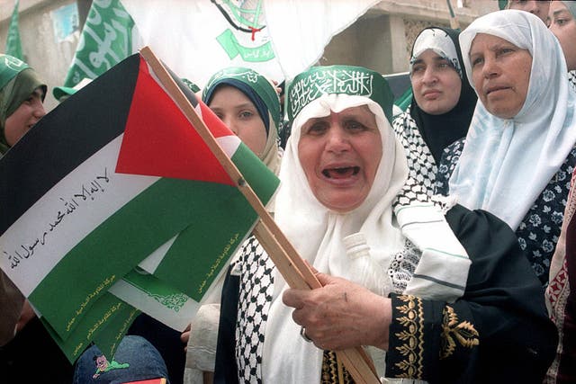 File photo of Palestinian women carry their national flags in a demonstration in support of Islamic militant movement Hamas