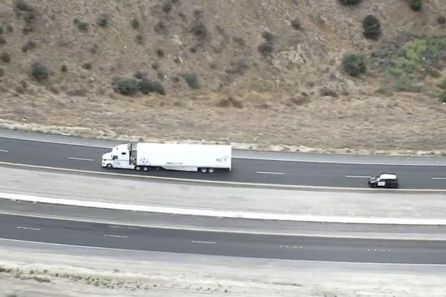A California Highway Patrol cruiser pursues the rig through the Southern California desert on Tuesday